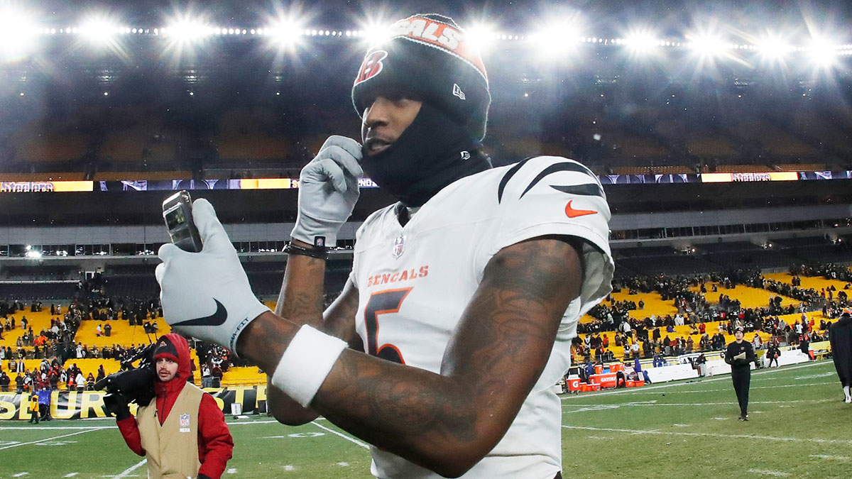 Cincinnati Bengals wide receiver Tee Higgins (5) goes live on social media after defeating the Pittsburgh Steelers at Acrisure Stadium.