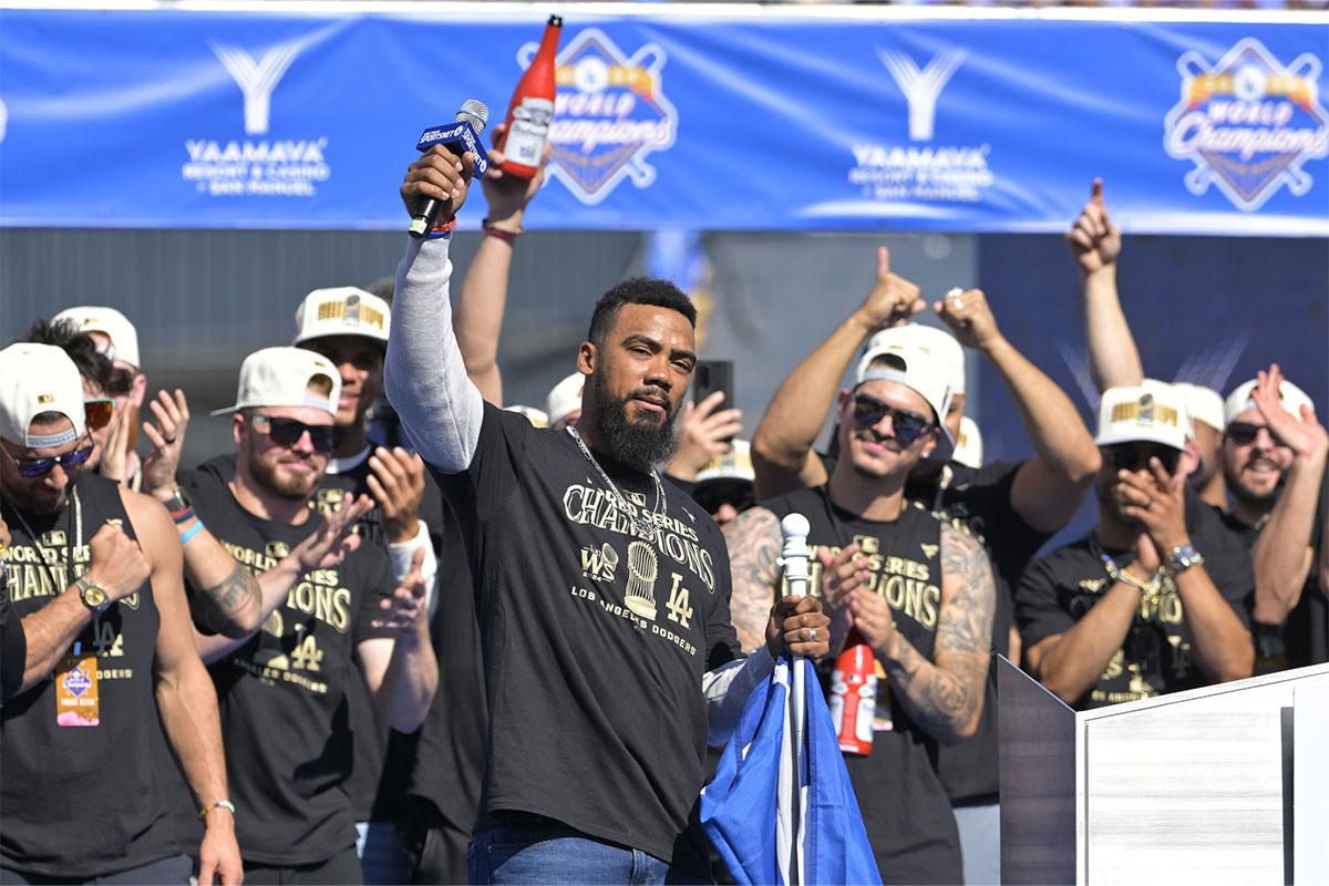 Los Angeles Dodgers left fielder Teoscar Hernandez (37) speaks to fans during the World Series Championship Celebration at Dodger Stadium.