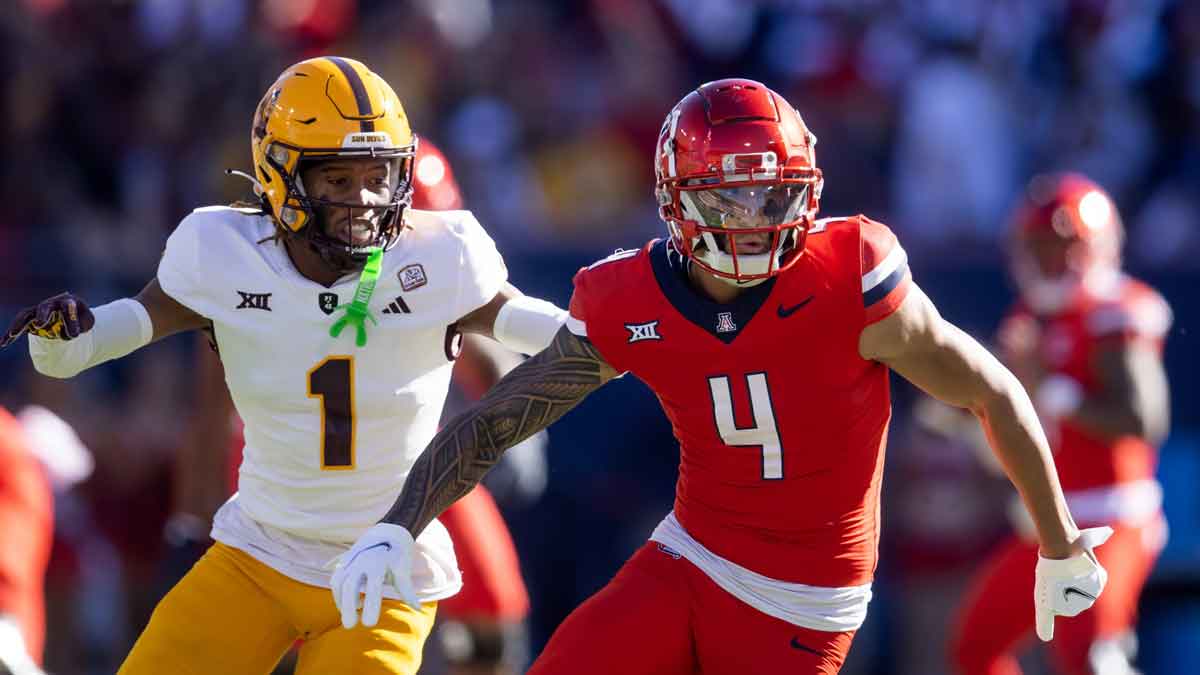 Nov 30, 2024; Tucson, Arizona, USA; Arizona Wildcats wide receiver Tetairoa McMillan (4) against Arizona State Sun Devils defensive back Keith Abney II (1) during the Territorial Cup at Arizona Stadium. Mandatory Credit: Mark J. Rebilas-Imagn Images