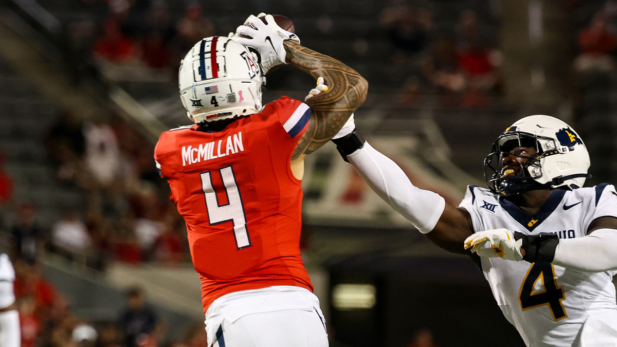 Jedd Fisch's Arizona Wildcats wide receiver Tetairoa McMillan (4) catches a long pass while West Virginia Mountaineers linebacker Trey Lathan (4) fails to defend against him during the fourth quarter at Arizona Stadium.