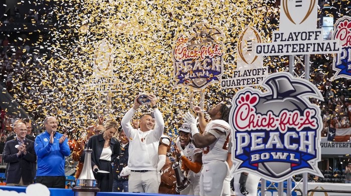 Texas Longhorns head coach Steve Sarkisian lifts the trophy after defeating the Arizona State Sun Devils at Mercedes-Benz Stadium.