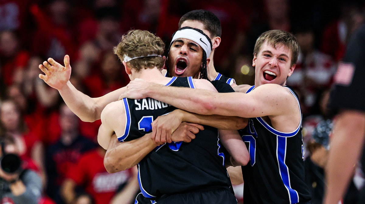 BYU Cougars center Keba Keita (13), guard Trey Stewart (1) and guard Dallin Hall (30) celebrate a win against the Arizona Wildcats at the end of the game at McKale Center.