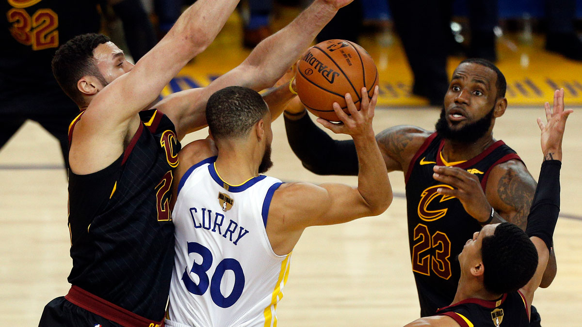 Cleveland Cavaliers forward Larry Nance Jr. (22) forward LeBron James (23) and guard Jordan Clarkson (8) defend against Golden State Warriors guard Stephen Curry (30) during the first half in game one of the 2018 NBA Finals at Oracle Arena.