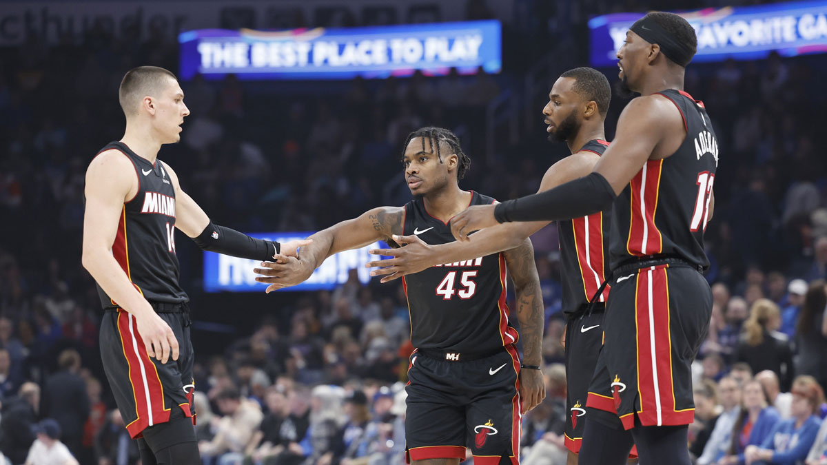 Miami Heat guard Tyler Herro (14), guard Davion Mitchell (45), forward Andrew Wiggins (22) and center Bam Adebayo (13) high five after a play against the Oklahoma City Thunder during the first quarter at Paycom Center.