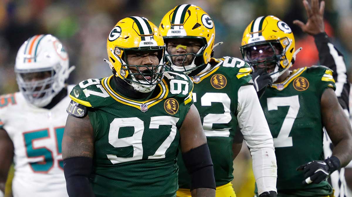 Green Bay Packers defensive tackle Kenny Clark (97) celebrates sacking Miami Dolphins quarterback Tua Tagovailoa with defensive end Rashan Gary (52) and linebacker Quay Walker (7) during their football game Thursday, November 28, 2024, at Lambeau Field in Green Bay, Wisconsin.