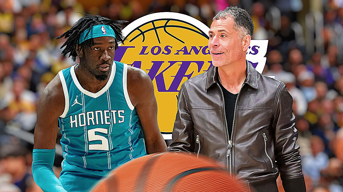 Hornets center Mark Williams next to Lakers president of basketball operations Rob Pelinka with the Lakers logo in the background