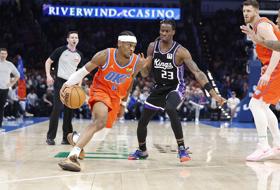 Thunder Guard Shai Gilgeous-Alexander (2) Drive to Cart around Sacramento Kings Keeper Keon Ellis (23) During the second half in Paycom Center