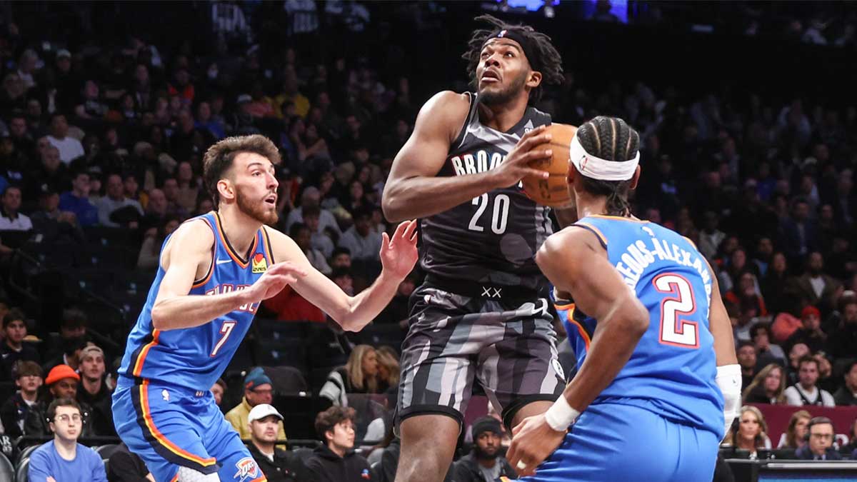 Nets center Day'Ron Sharpe (20) looks to drive past Oklahoma City Thunder forward Chet Holmgren (7) and guard Shai Gilgeous-Alexander (2) in the third quarter at Barclays Center