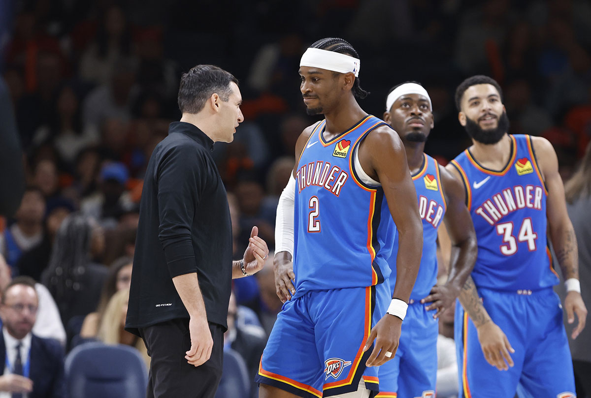 Thunder guard Shai Gilgeous-Alexander (2) and head coach Mark Daigneault talk during a time out against the New Orleans Pelicans during the second quarter at Paycom Center