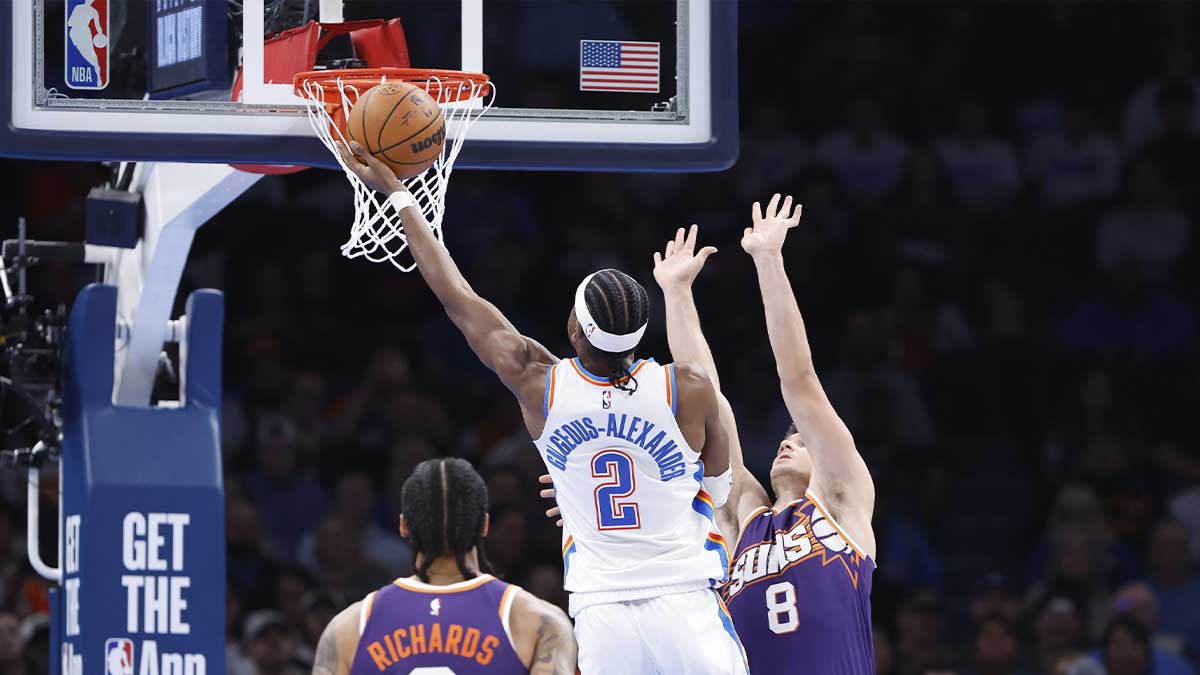 Oklahoma City Thunder Guard Shai Gilgeous-Alexander (2) Recording as Phoenix Suns Guard Greison Allen (8) ends during the second half of the game in Paicom center.