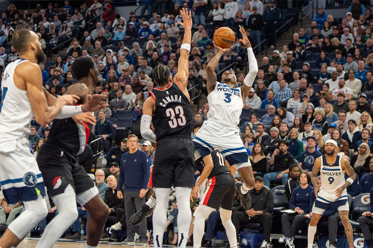 Minnesota Timbervolves Next Jaden McDaniels (3) Shoots against Portland Trail Blazers Forward Toumani Camara (33) in the fourth quarter at the target center.