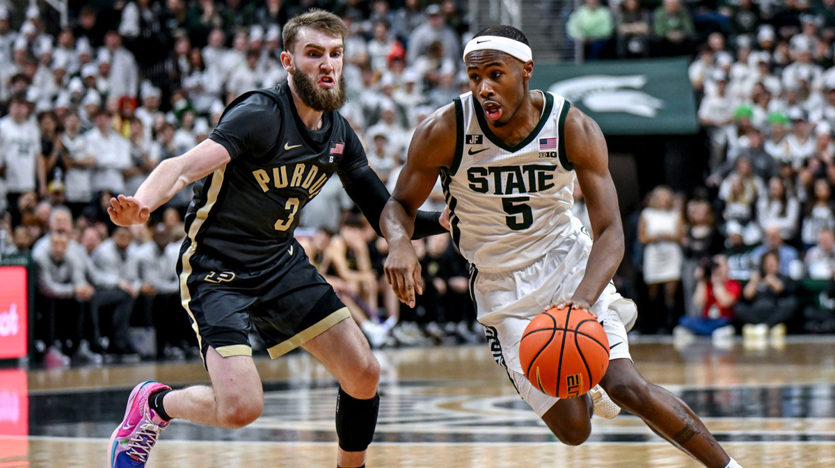 Michigan State's Tre Holloman, right, moves past Purdue's Braden Smith during the second half on Tuesday, Feb. 18, 2025, at the Breslin Center in East Lansing.