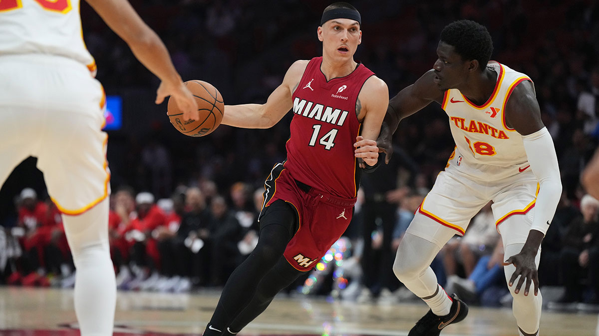 Miami Heat guard Tyler Herro (14) drives past Atlanta Hawks forward Mouhamed Gueye (18) in the first half at Kaseya Center.