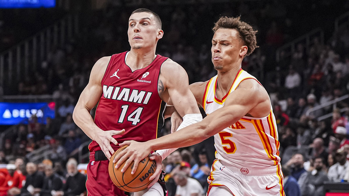 Miami heat garnid Tyler Herro (14) tries to protect the ball against Atlanta Hawks Guard Disison Daniels (5) during the first half of the Arena state farm.