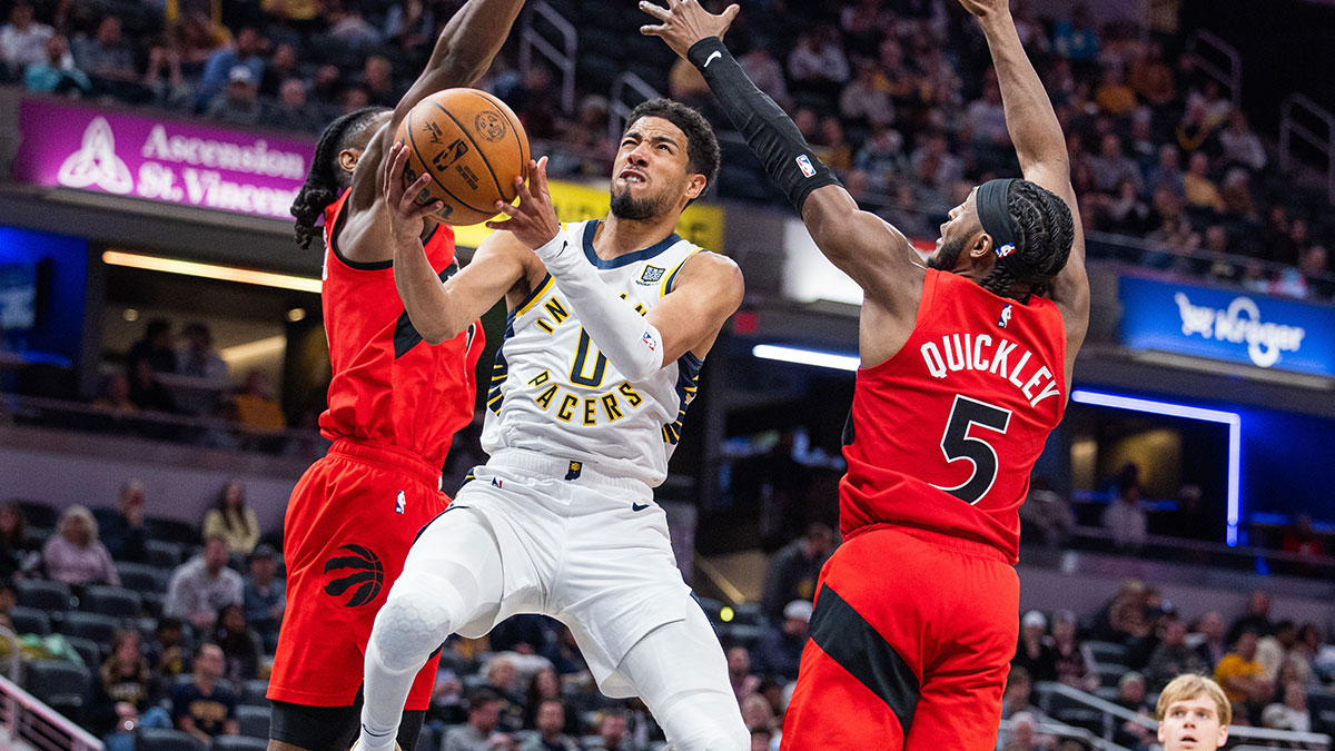 The Indiana Pacers Tyrese Haliburton (0) goalkeeper fits on the ball while the Toronto Immanuel Quickley (5) Raptors goalkeeper defends in the second period at Gainbridge Fieldhouse.