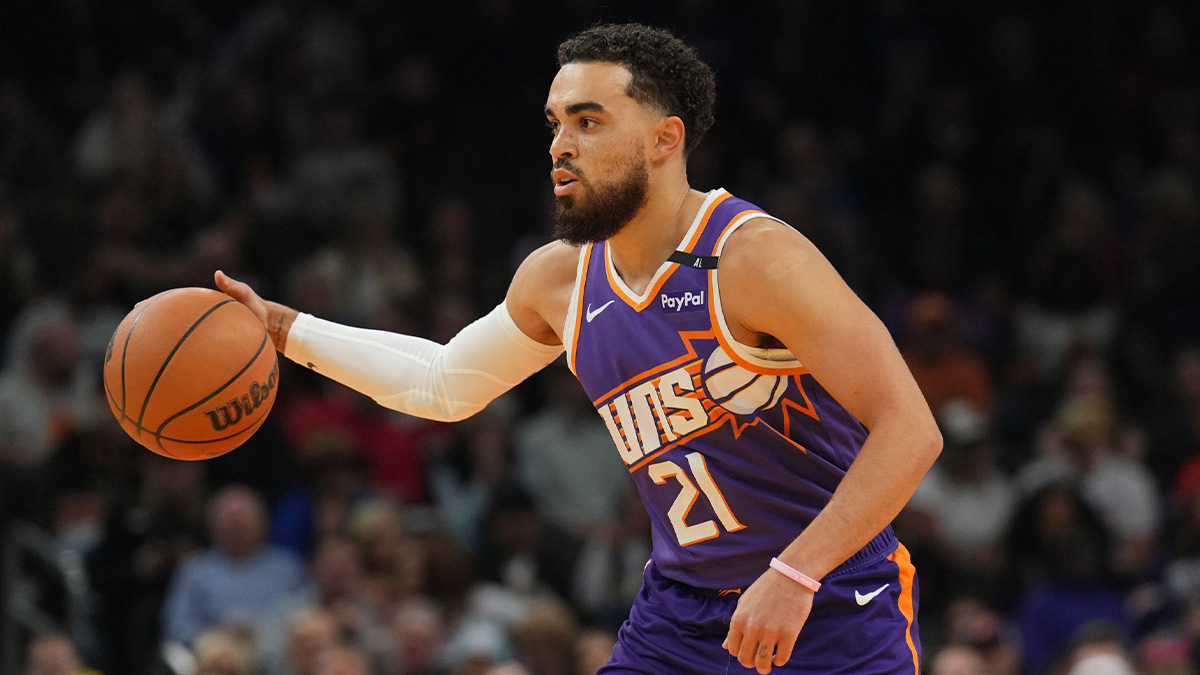 Phoenix Suns guard Tyus Jones (21) dribbles against the Denver Nuggets during the first half at Footprint Center