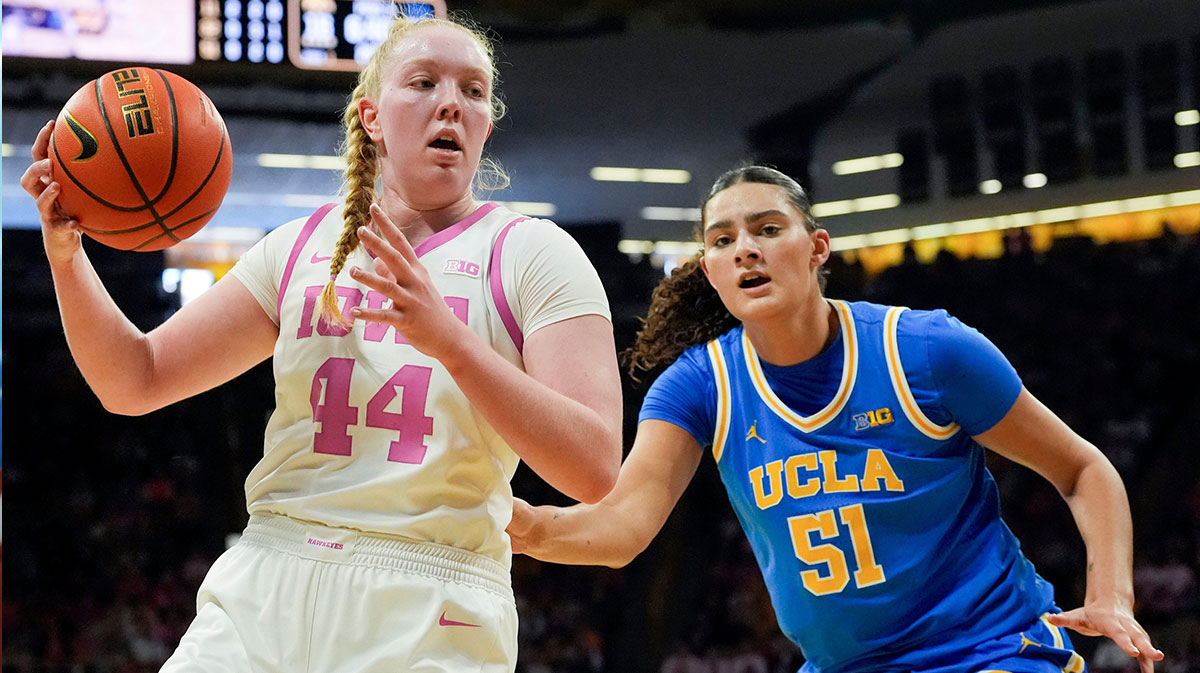 Iowa forward Addison O'Grady (44) catches an inbound pass as UCLA center Lauren Betts (51) defends.