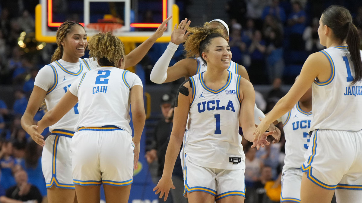 UCLA Bruins guard Avary Cain (2), forward Kendall Dudley (22) and guard Kiki Rice (1) and guard Gabriela Jaquez (11) celebrate at the end of the game against the UCLA Bruins.