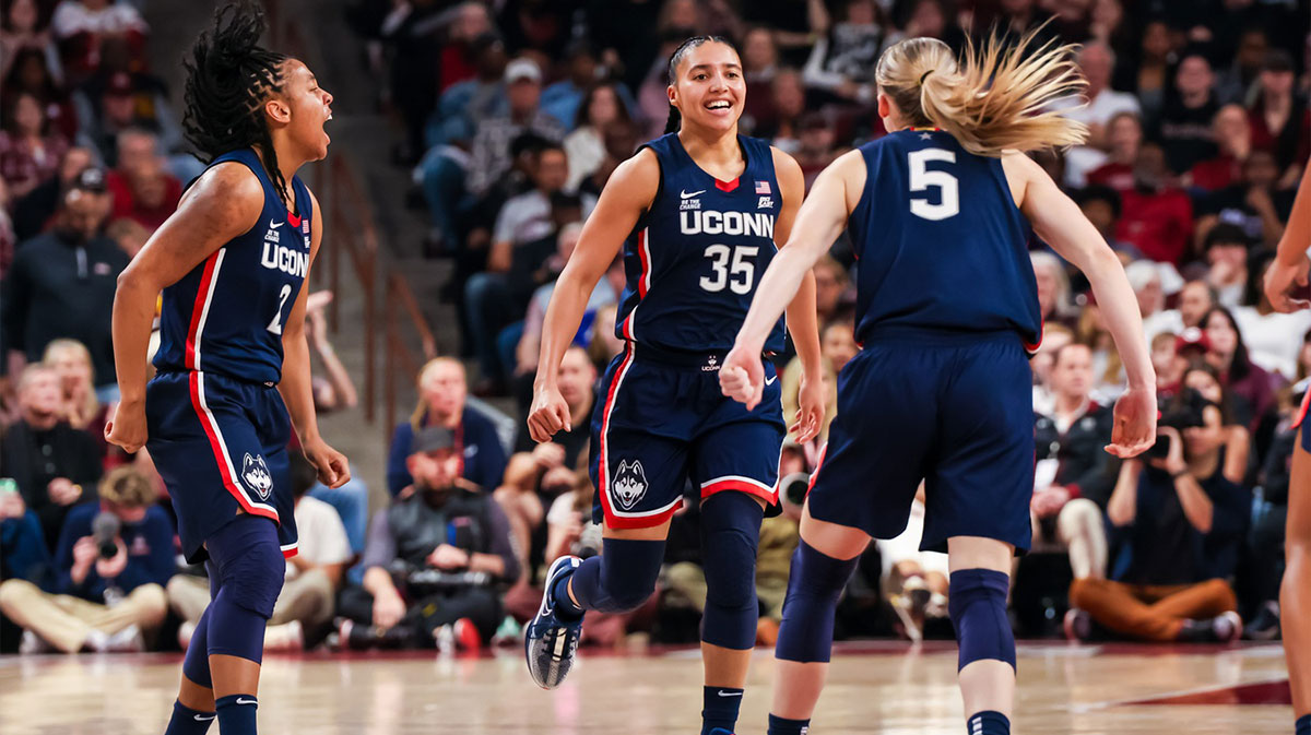 UConn Huskies guard KK Arnold (2), guard Azzi Fudd (35) and guard Paige Bueckers (5) celebrate a three point basket against the South Carolina Gamecocks in the first half at Colonial Life Arena.