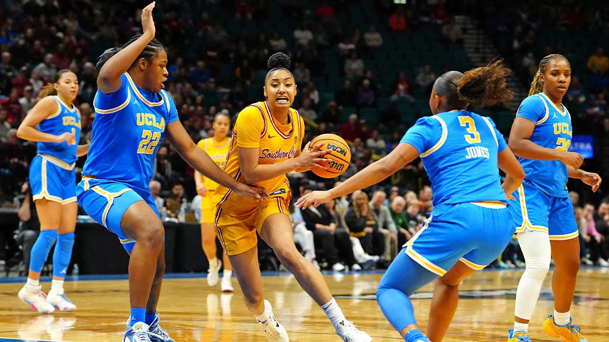 USC Trojans guard JuJu Watkins (12) drives the lane between UCLA Bruins forward Christeen Iwuala (22) and UCLA Bruins guard Londynn Jones (3) during the third quarter.
