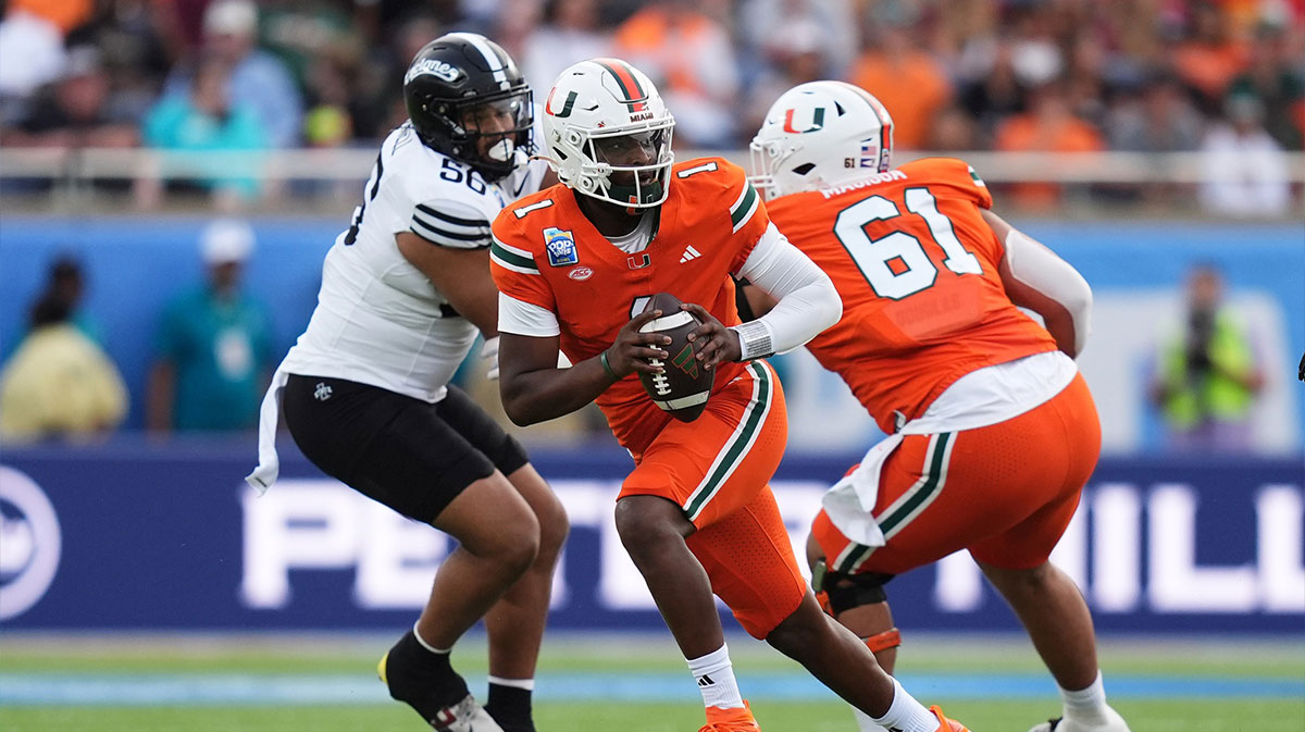 Miami Hurricanes quarterback Cam Ward (1) scrambles with the ball against the Iowa State Cyclones during the first half at Camping World Stadium.