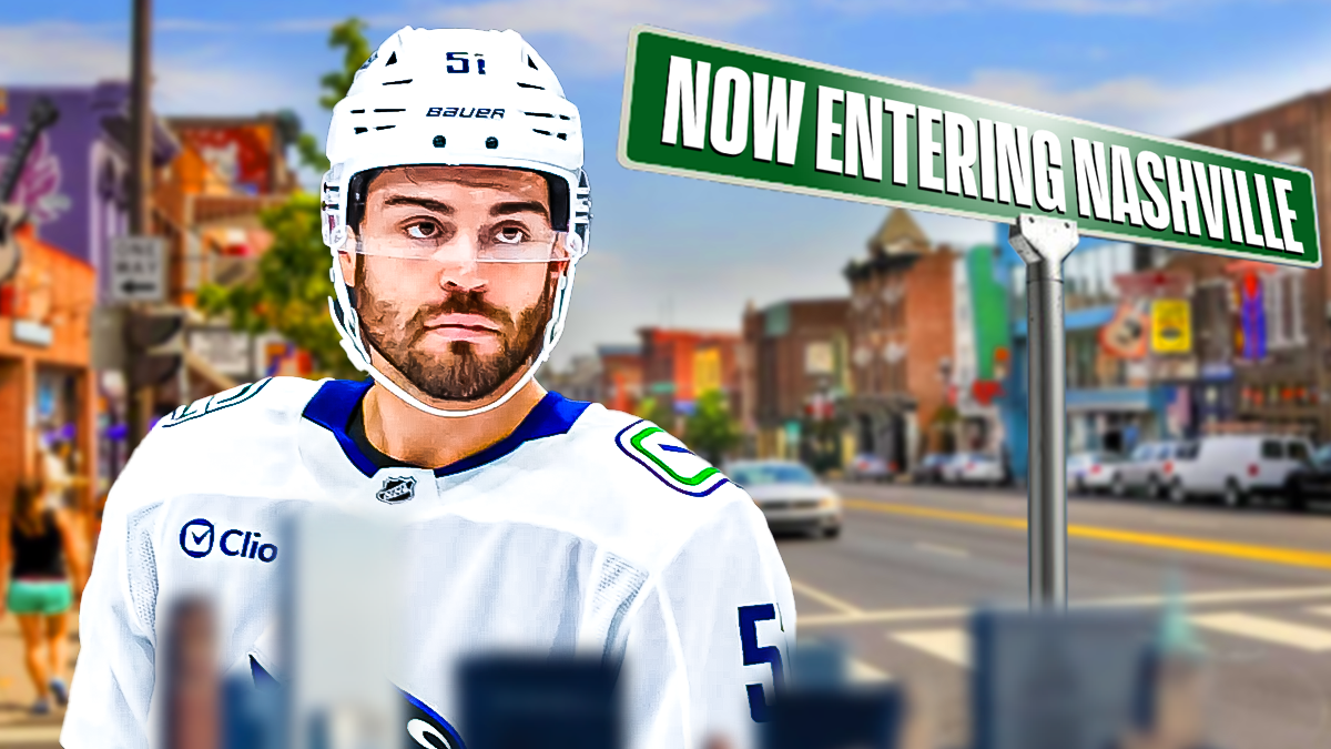 Canucks depth defenseman Mark Friedman on the left, sign on the right with "Now entering Nashville" on the right, on Broadway street in Nashville