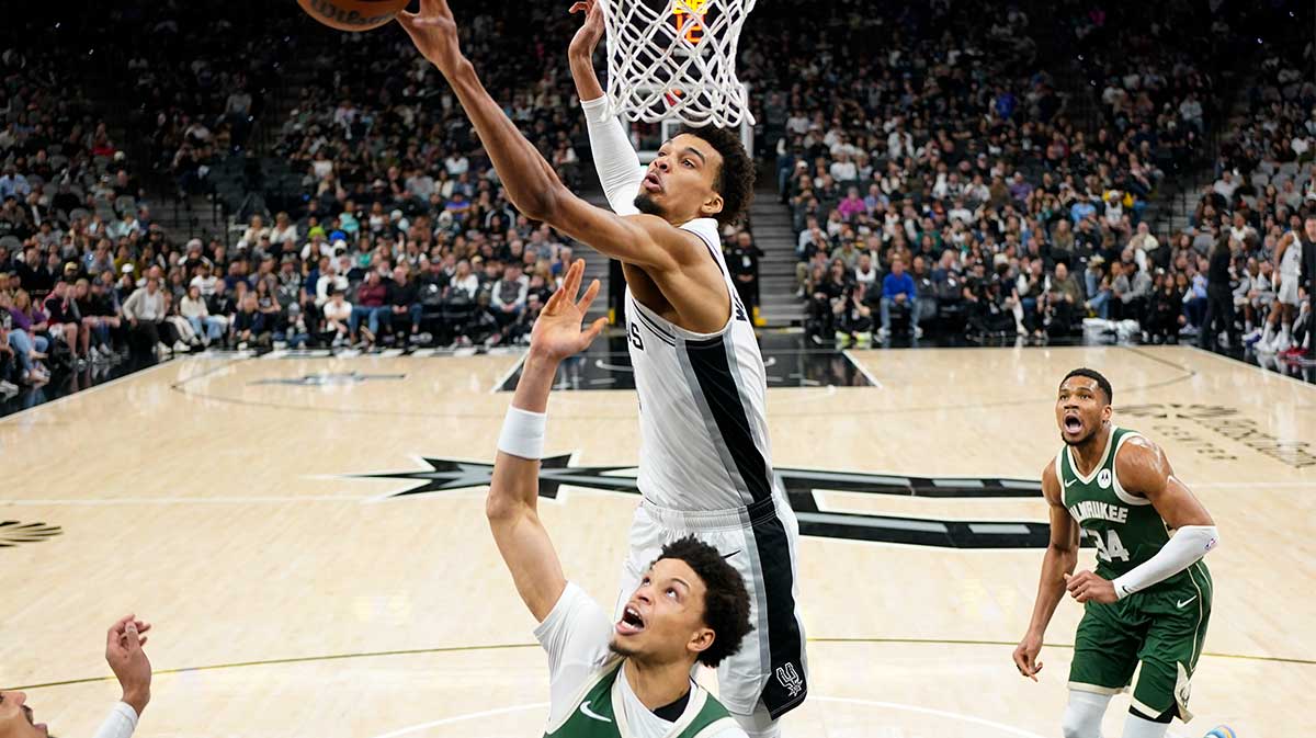 San Antonio Spurs center Victor Wembanyama (1) blocks the shot attempt by Milwaukee Bucks guard Ryan Rollins (13) during the first half at Frost Bank Center.