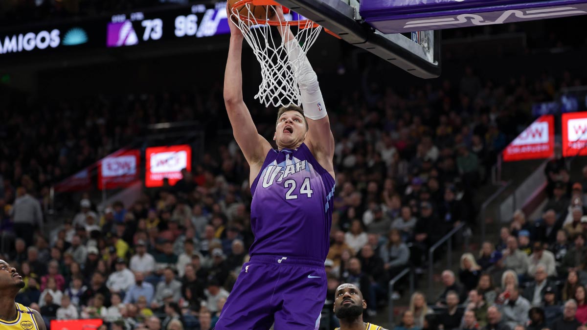 Utah Jazz center Walker Kessler (24) dunks against Los Angeles Lakers forward Lebron James (23) during the second half at Delta Center.
