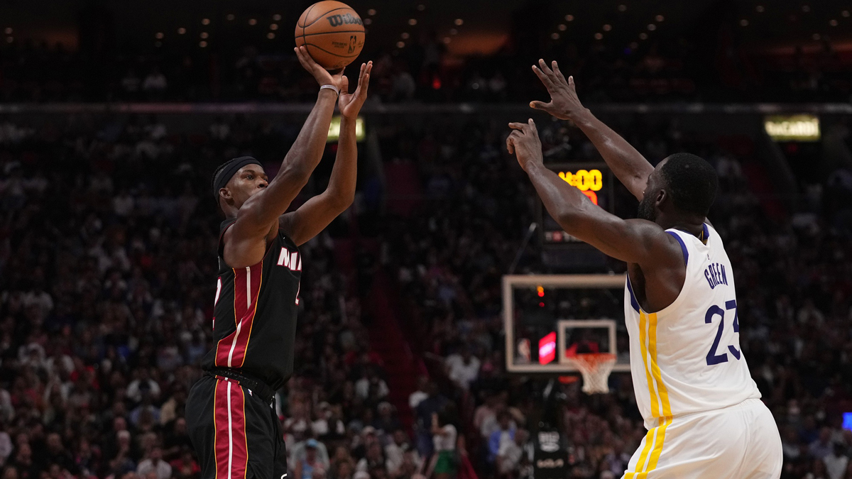 Miami Heat forward Jimmy Butler (22) shoots the ball over Golden State Warriors forward Draymond Green (23) during the second half at FTX Arena.