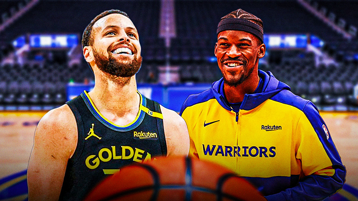 Jimmy Butler giving a thumbs up towards Stephen Curry smiling, with the Warriors home arena in the background.