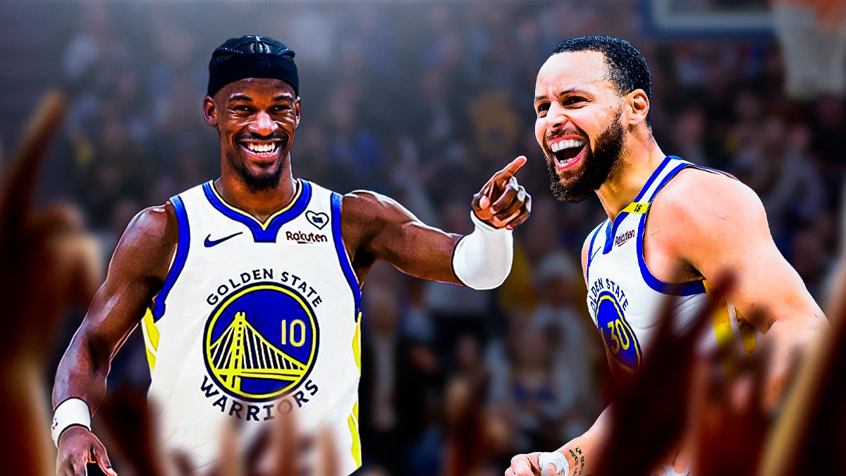 Jimmy Butler smiling in Warriors uniform pointing to Stephen Curry