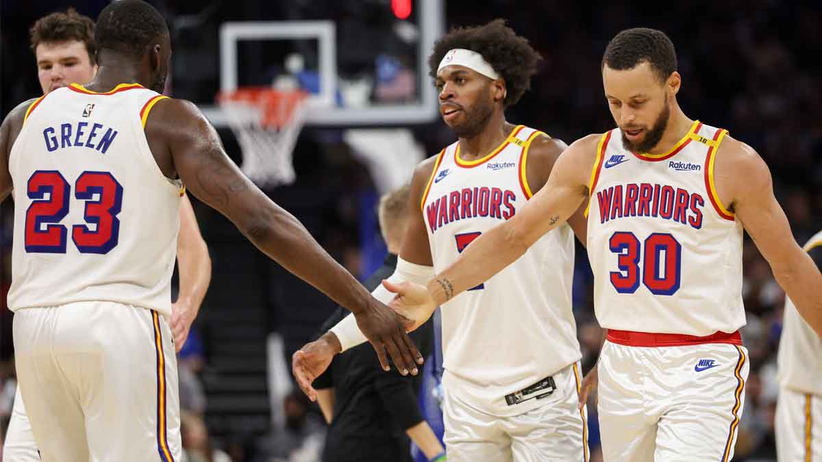 Golden State Warriors guard Stephen Curry (30) and forward Draymond Green (23) celebrate after a play against the Orlando Magic in the third quarter at Kia Center.