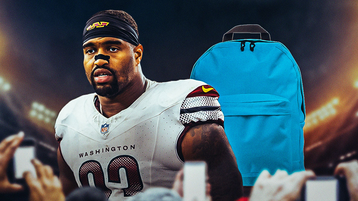 Commanders defensive end Jonathan Allen with a backpack on and looking away from the Commanders home stadium.