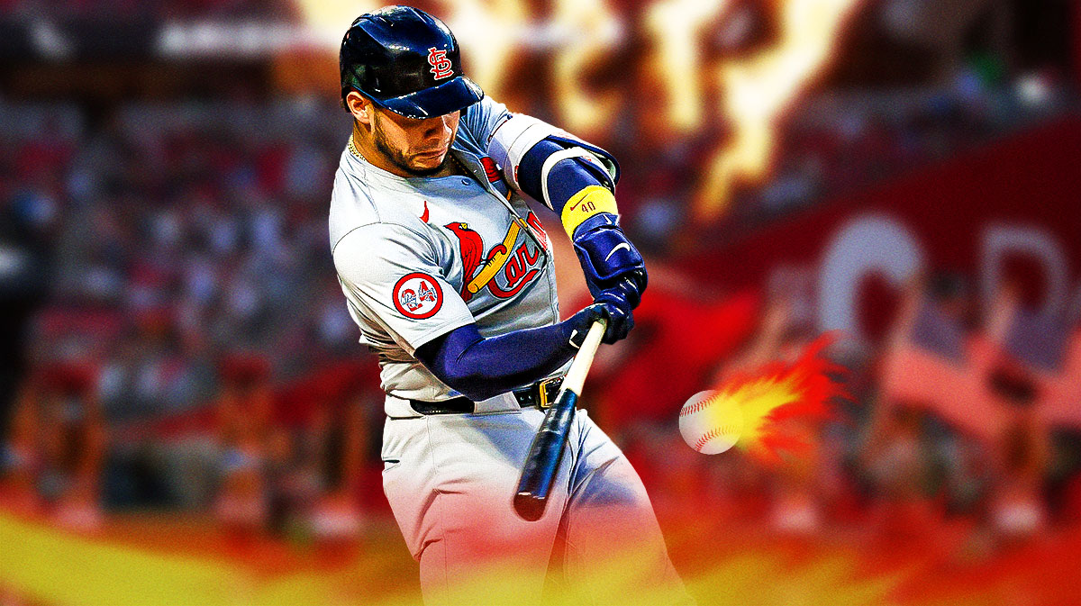 Willson Contreras hitting a baseball with flames coming off of his bat