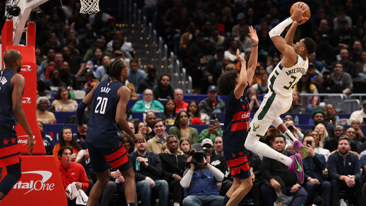 Milwaukee Bucks forward Giannis Antetokounmpo (34) shoots the ball over Washington Wizards forward Kyshawn George (18) in the second half at Capital One Arena.