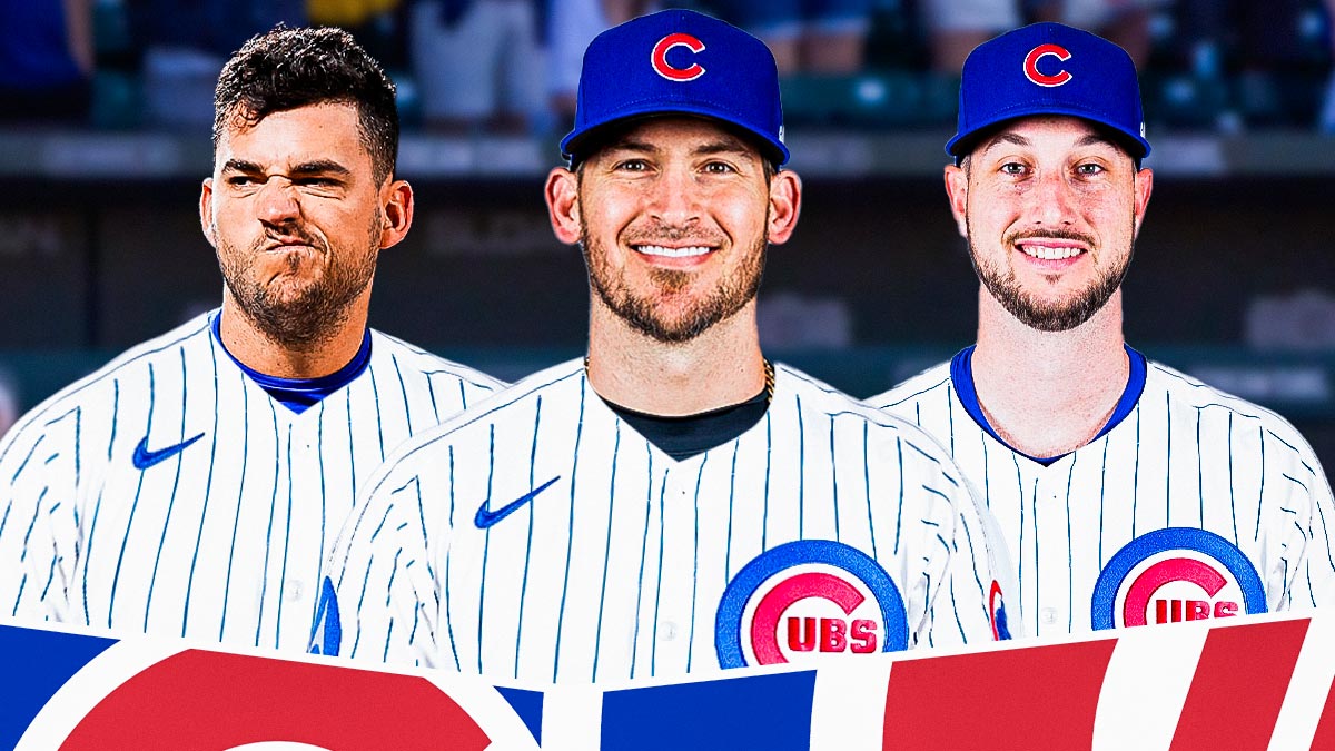 Yasmani Grandal in a Cubs uniform standing next to Jose Iglesias in a Cubs uniform next to Kyle Tucker also in a Cubs uniform.