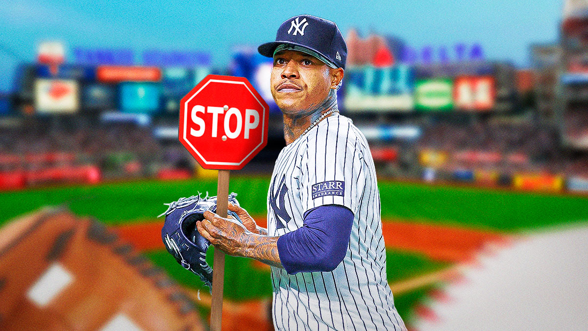 Yankees Marcus Stroman holding up a stop sign and looking serious.