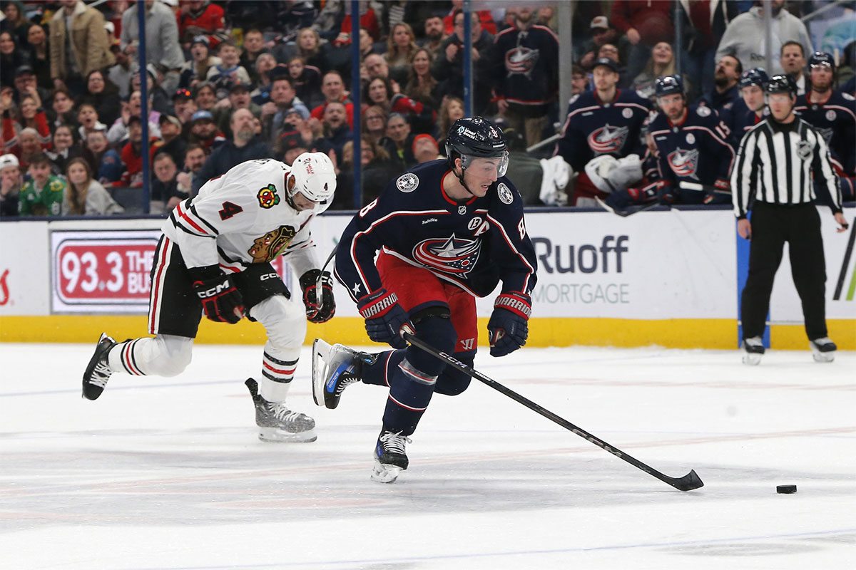 Columbus Blue Jackets defenseman Zach Werenski (8) skates in on a breakaway as Chicago Blackhawks defenseman Seth Jones (4) trails the play during the third period at Nationwide Arena. 