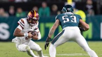Nov 14, 2024; Philadelphia, Pennsylvania, USA; Washington Commanders quarterback Jayden Daniels (5) slides in front of Philadelphia Eagles linebacker Zack Baun (53) during the second quarter at Lincoln Financial Field.