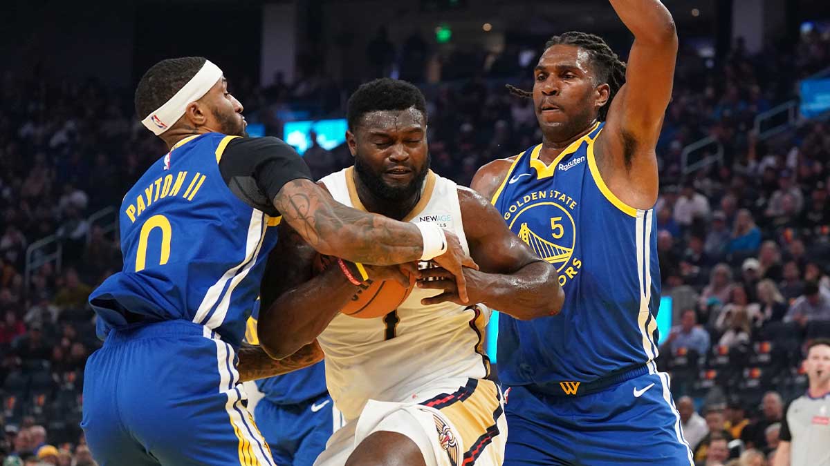 New Orleans Pelicans forwards Zion Williamson (1) Dribbles against golden state warriors Guard Gary Payton II (0) and Kevon Looney (5) during the second quarter in Chese Center.