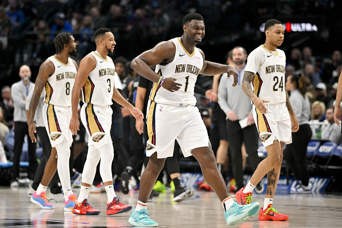 New Orleans Pelicans forward Naji Marshall (8) and guard CJ McCollum (3) and forward Zion Williamson (1) and guard Jordan Hawkins (24) celebrate during the game between the Dallas Mavericks and the New Orleans Pelicans at the American Airlines Center.