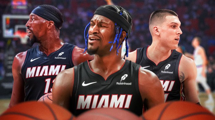 Former Miami Heat star Jimmy Butler in the middle with Bam Adebayo and Tyler Herro on either side in front of Kaseya Center.