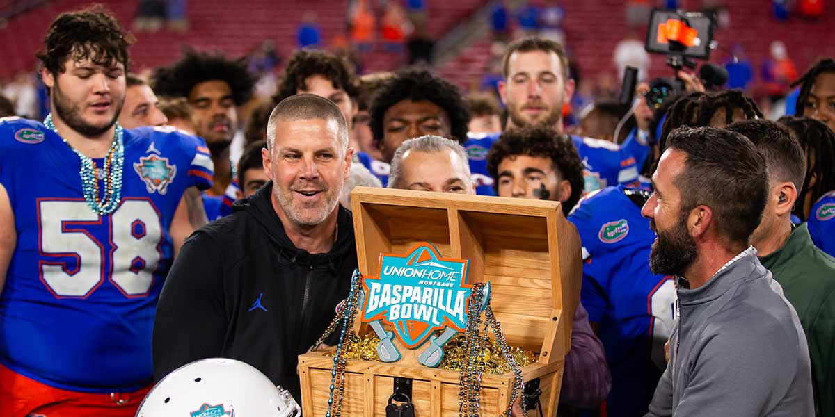 Florida Gators head coach Billy Napier lifts the 2024 Union Home Mortgage Gasparilla Bowl trophy in Raymond James Stadium in Tampa, FL on Friday, December 20, 2024 after defeating Tulane 33-8. [Doug Engle/Gainesville Sun]