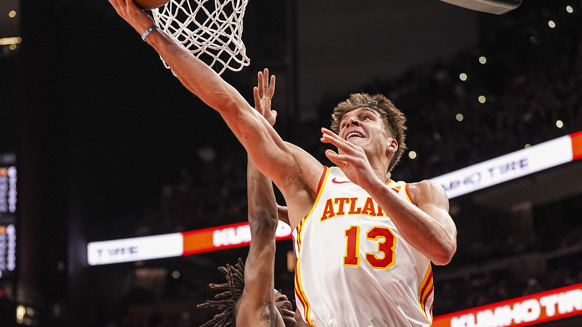 Atlanta Hawks Guard Bogdan Bogdanovic (13) goes to the basket of last Toronto Raptors Guard Ja'kobe Valter (14) during the first half at the State Farm Arena. 