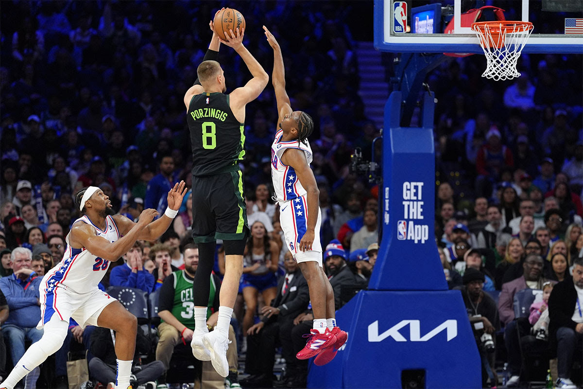 Boston Celtics forward Kristaps Porzingis (8) shoots the ball against Philadelphia 76ers guard Tyrese Maxey (0) in the fourth quarter at Wells Fargo Center.