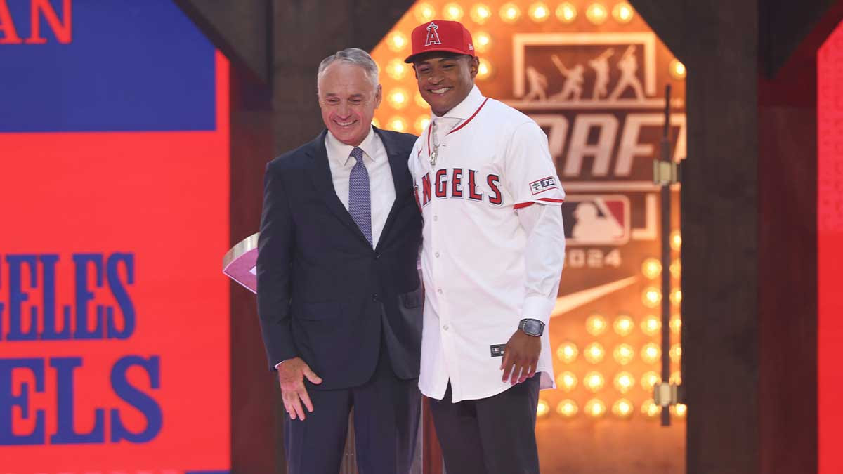 Christian Moore is congratulated by MLB commissioner Rob Manfred after being selected by the Los Angeles Angels as the eight player taken during the first round of the MLB Draft at Cowtown Coliseum.