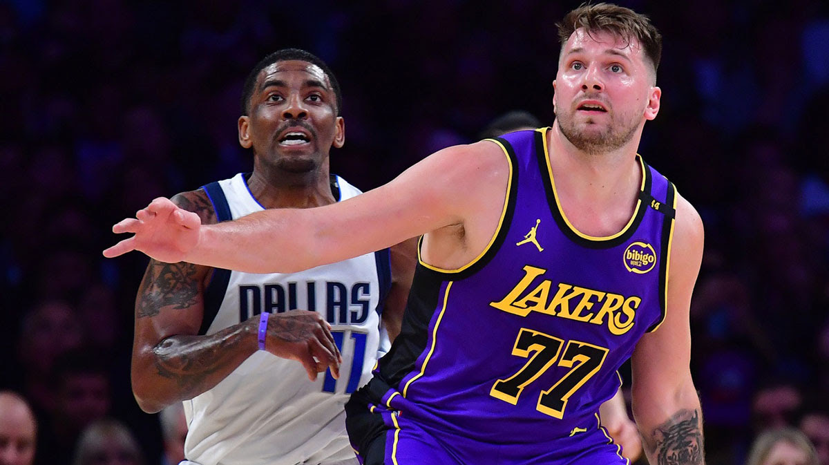 Los Angeles Lakers guard Luka Doncic (77) and Dallas Mavericks guard Kyrie Irving (11) attempt to gain control during the first quarter at Crypto.com Arena.