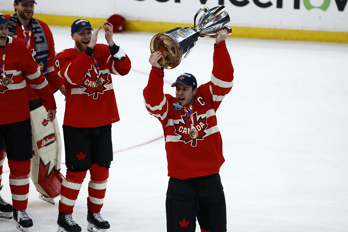 Team Canada forward Sidney Crosby (87) lifts the 4 Nations Face-Off trophy after winning against Team USA in overtime during the 4 Nations Face-Off ice hockey championship game at TD Garden. 