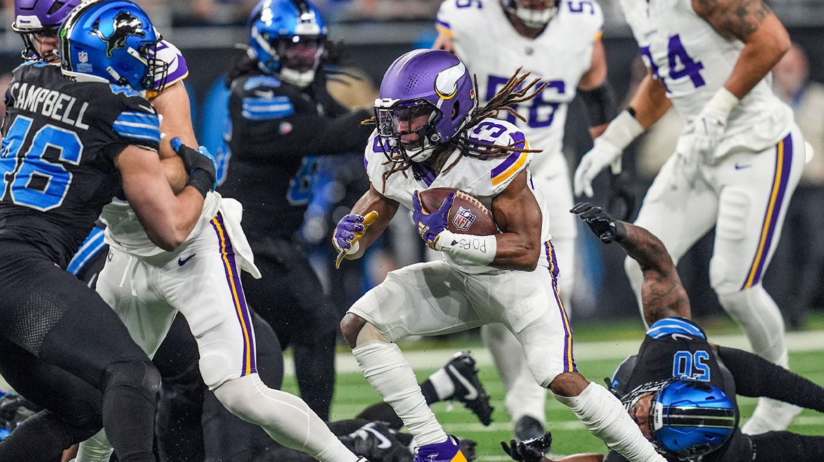 Minnesota Vikings running back Aaron Jones (33) runs for yards during the first half of the NFL game at Ford Field in Detroit on Sunday, Jan. 5, 2025.