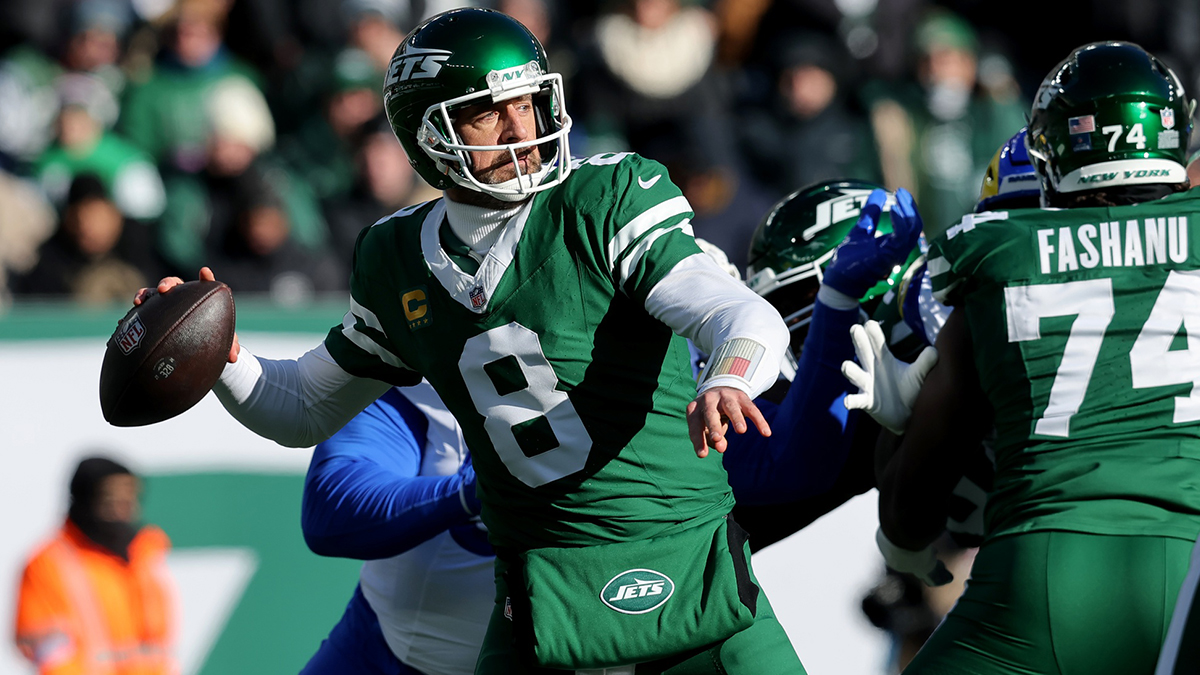 Dec 22, 2024; East Rutherford, New Jersey, USA; New York Jets quarterback Aaron Rodgers (8) drops back to pass against the Los Angeles Rams during the first quarter at MetLife Stadium. 